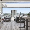 rooftop patio with view of a city